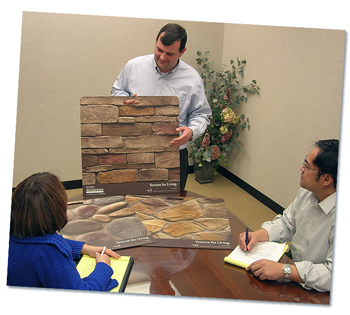 A client showing home product samples to the Walt Denny Inc. team